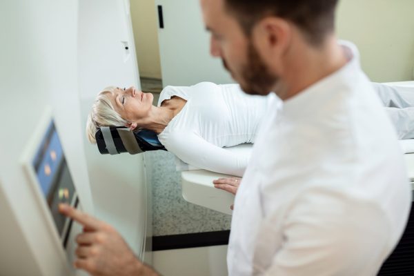 Mature woman having CT scanning examination in the hospital.