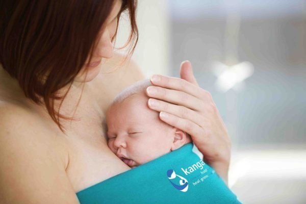 Mother holding sleeping baby girl